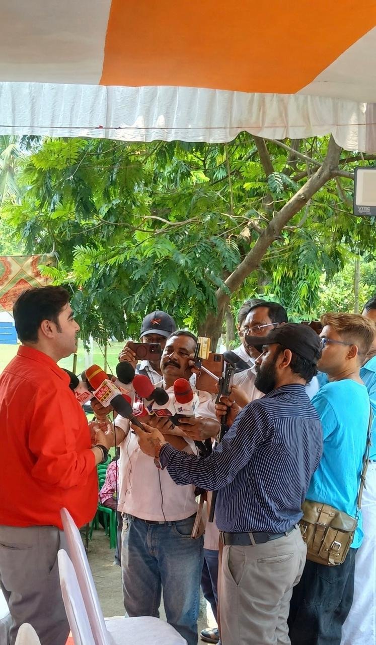 Fielding questions from television and print press at a public event.