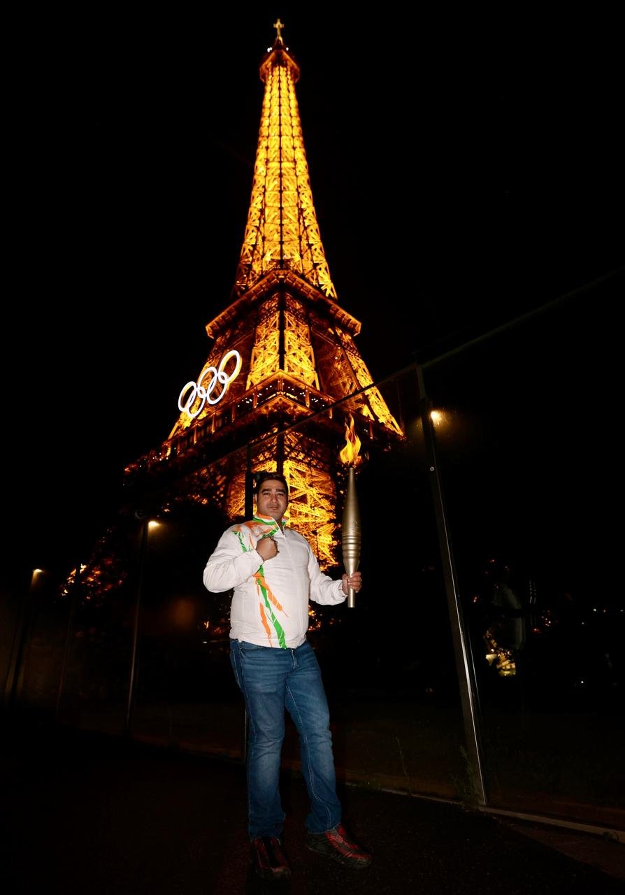 With the Olympic torch before the Eiffel Tower, as a delegate for the Indian boxing contingent at Paris 2024.
